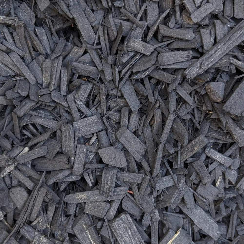 A Pile Of Black Mulch Is Sitting On The Ground — HKL Landscape Supplies in Taree South, NSW