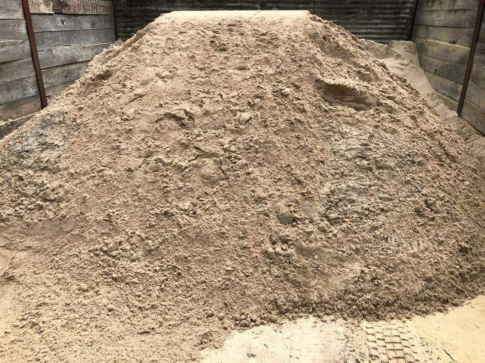 A Pile of Sand is Sitting on Top of a Wooden Table — HKL Landscape Supplies in Harrington, NSW