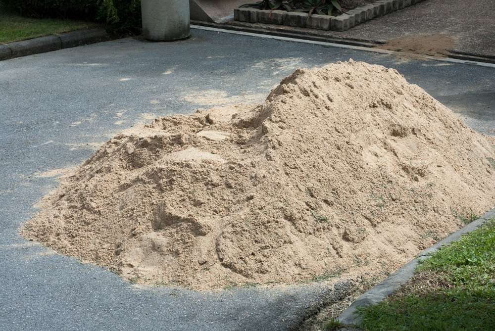 A Pile Of Sand Is Sitting On The Side Of A Road — HKL Landscape Supplies in Taree South, NSW