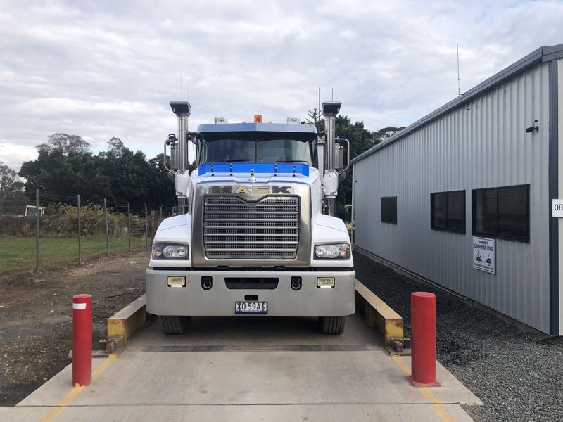 A Large Truck is Sitting on a Scale in Front of a Building — HKL Landscape Supplies in Nabiac, NSW 