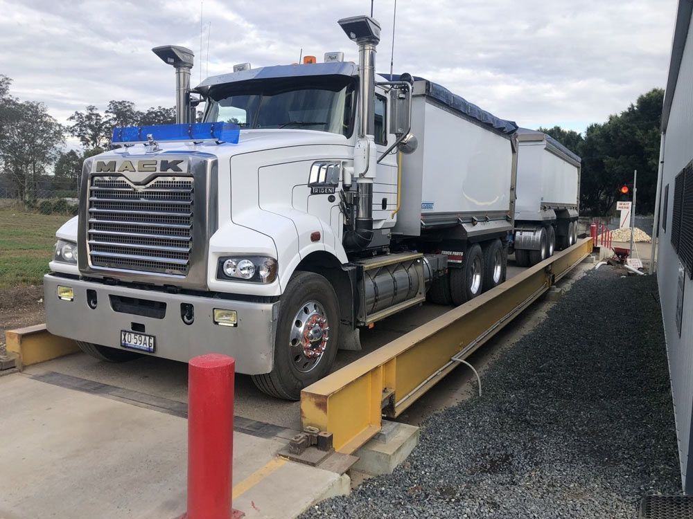 A Large White Truck is Sitting on a Scale — HKL Landscape Supplies in Taree South, NSW
