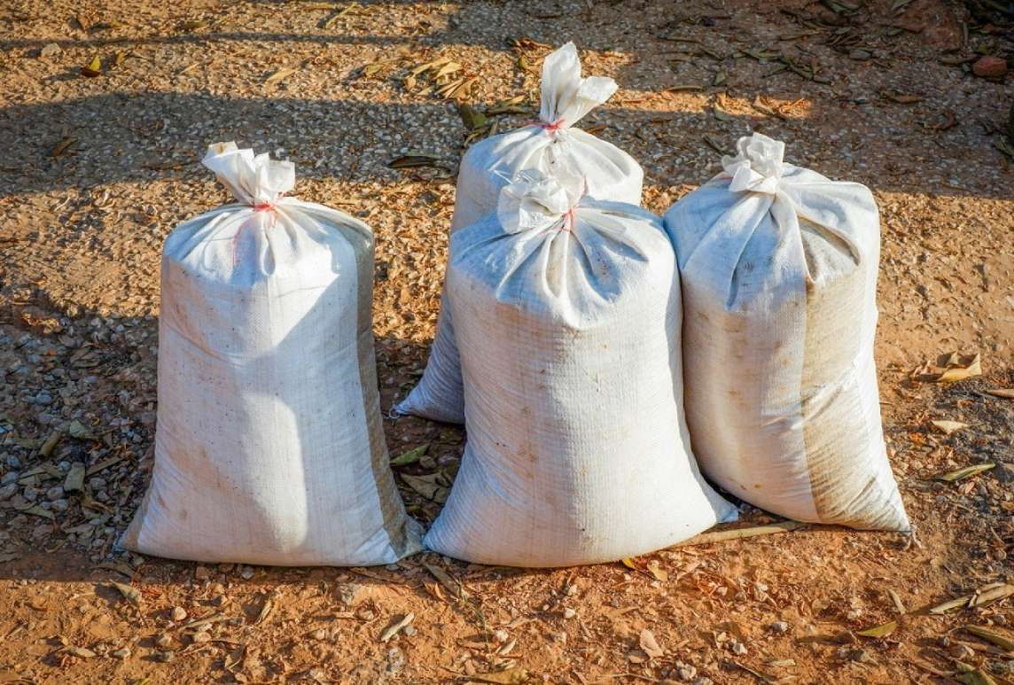 Three Bags Of Sand Are Sitting On The Ground — HKL Landscape Supplies in Old Bar, NSW 