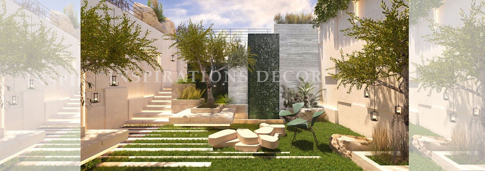 A modern outdoor courtyard with stone steps, grass, and a central green wall, bathed in sunlight.