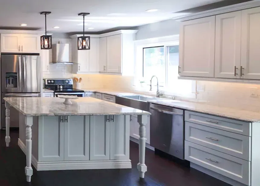 White custom kitchen cabinets with large island and modern lighting in Springfield MO remodel