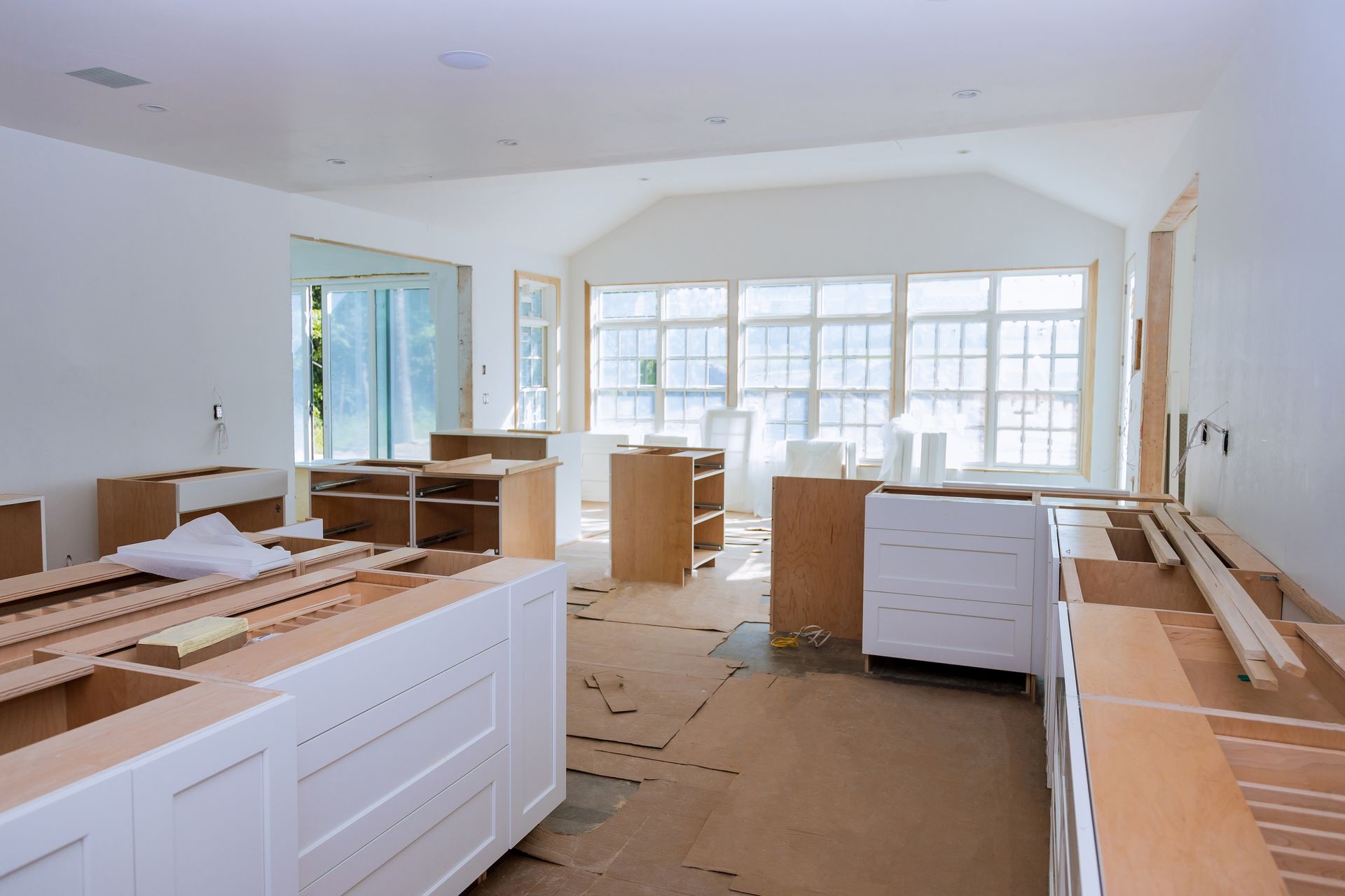 Kitchen remodel in progress with custom cabinets installed in a bright open space with natural light