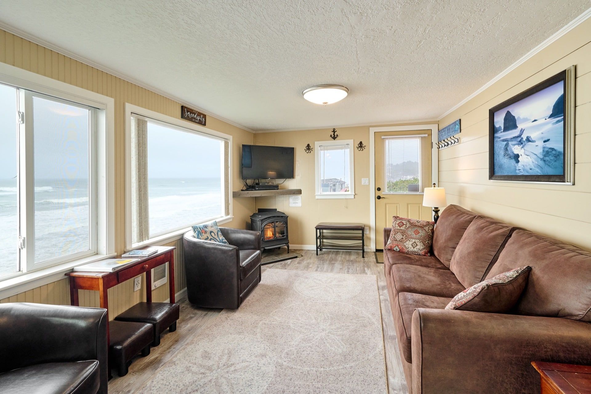 A living room with a couch , chairs , and a television.