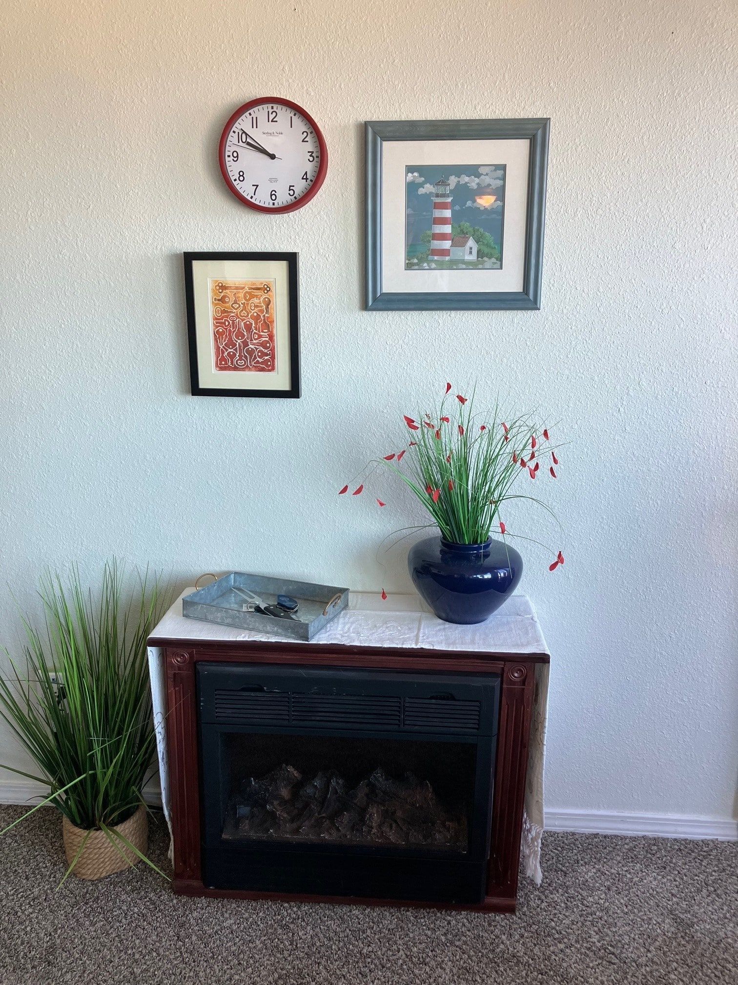 A living room with a fireplace and a clock on the wall.