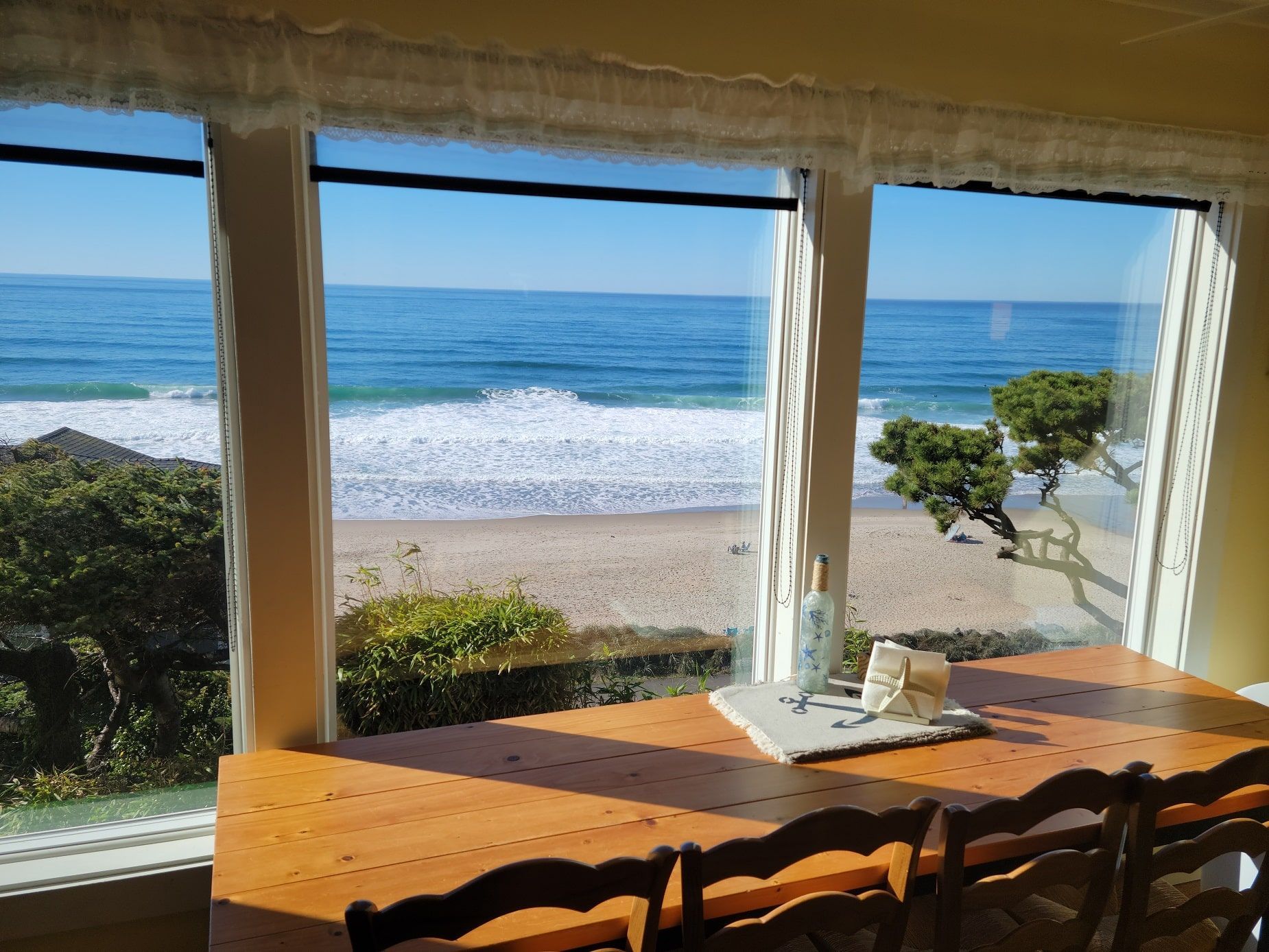 A dining room table with a view of the ocean