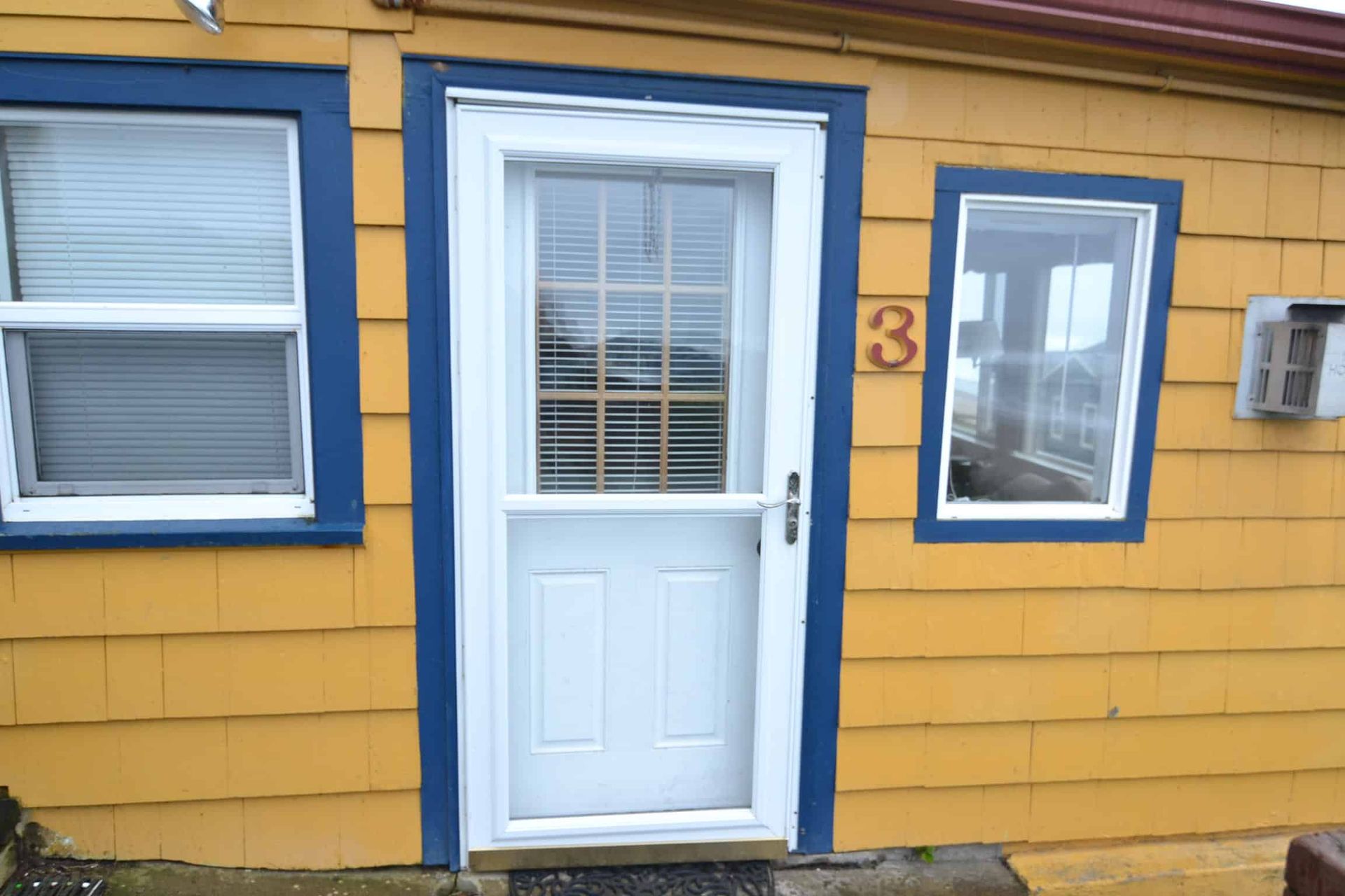 A yellow house with the number 3 on it
