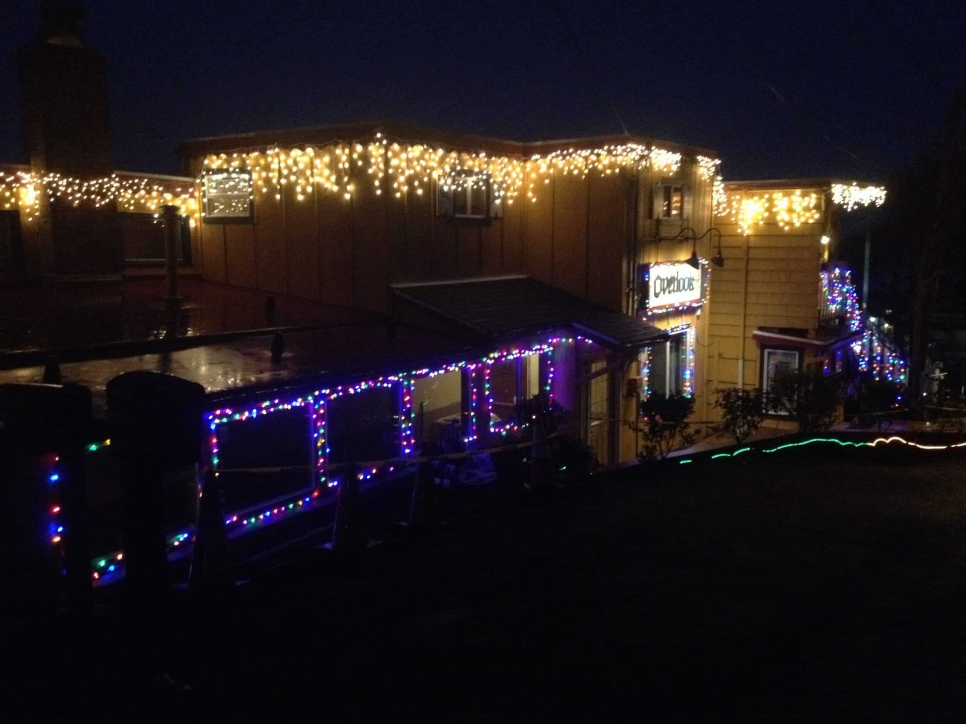 A building with christmas lights on it at night