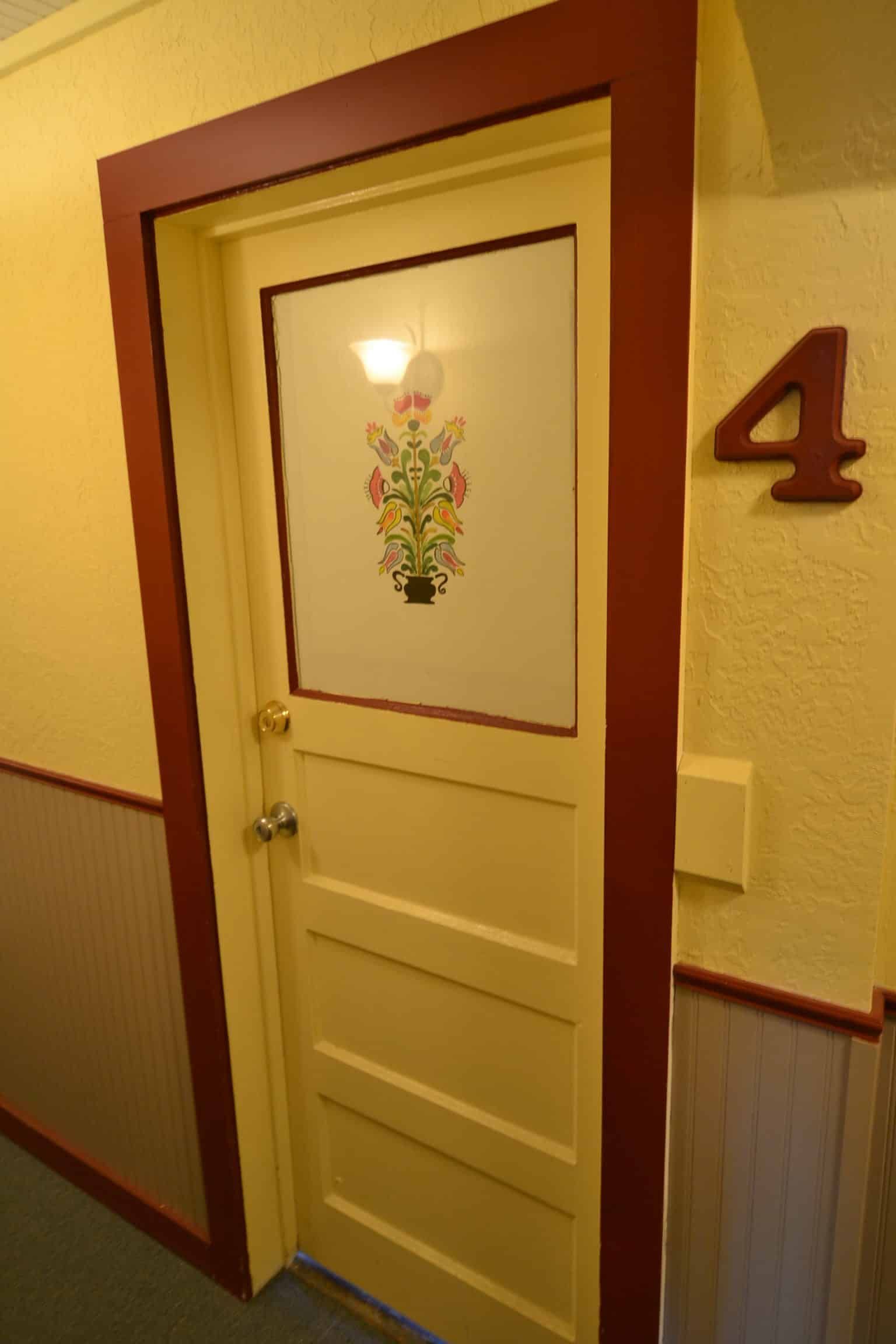 A door in a hallway with the number 4 on the wall