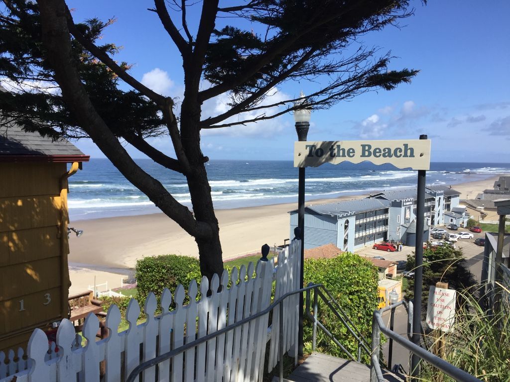 Stairs leading to the beach with a sign that says to the beach