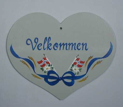A heart shaped sign that says velkommen on it
