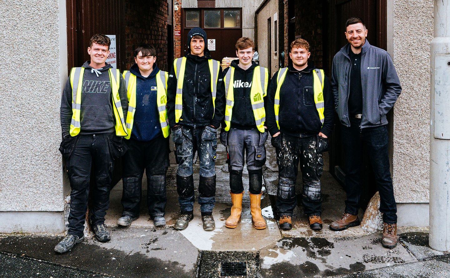Team of joiners in work clothes and high vis