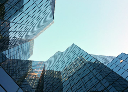 Looking up at a tall building with a blue sky in the background.