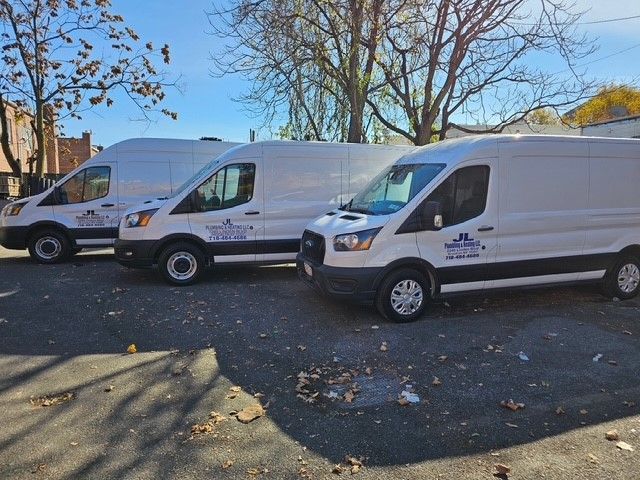 A white van is parked in front of a building.