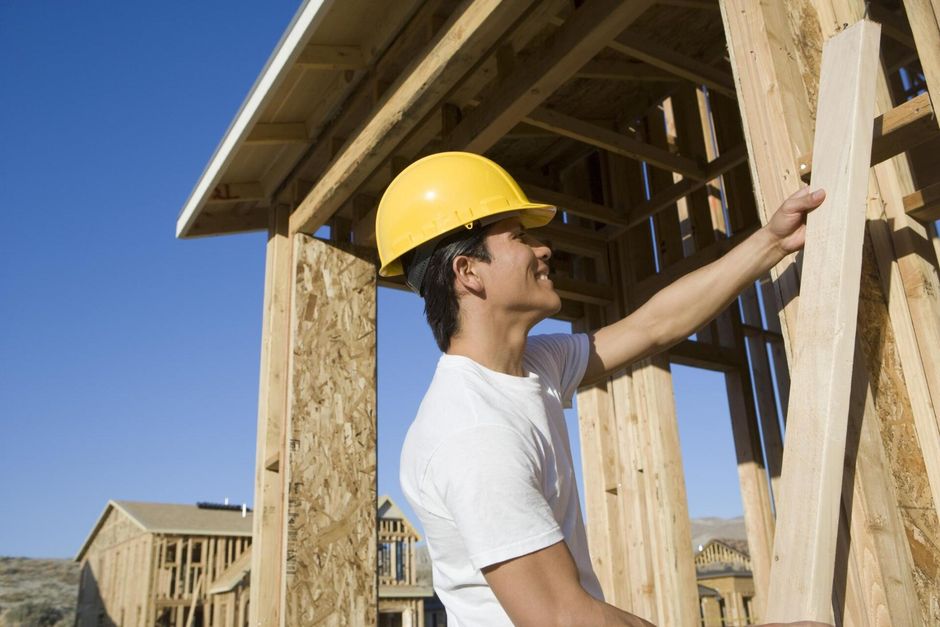 male worker putting wood bar