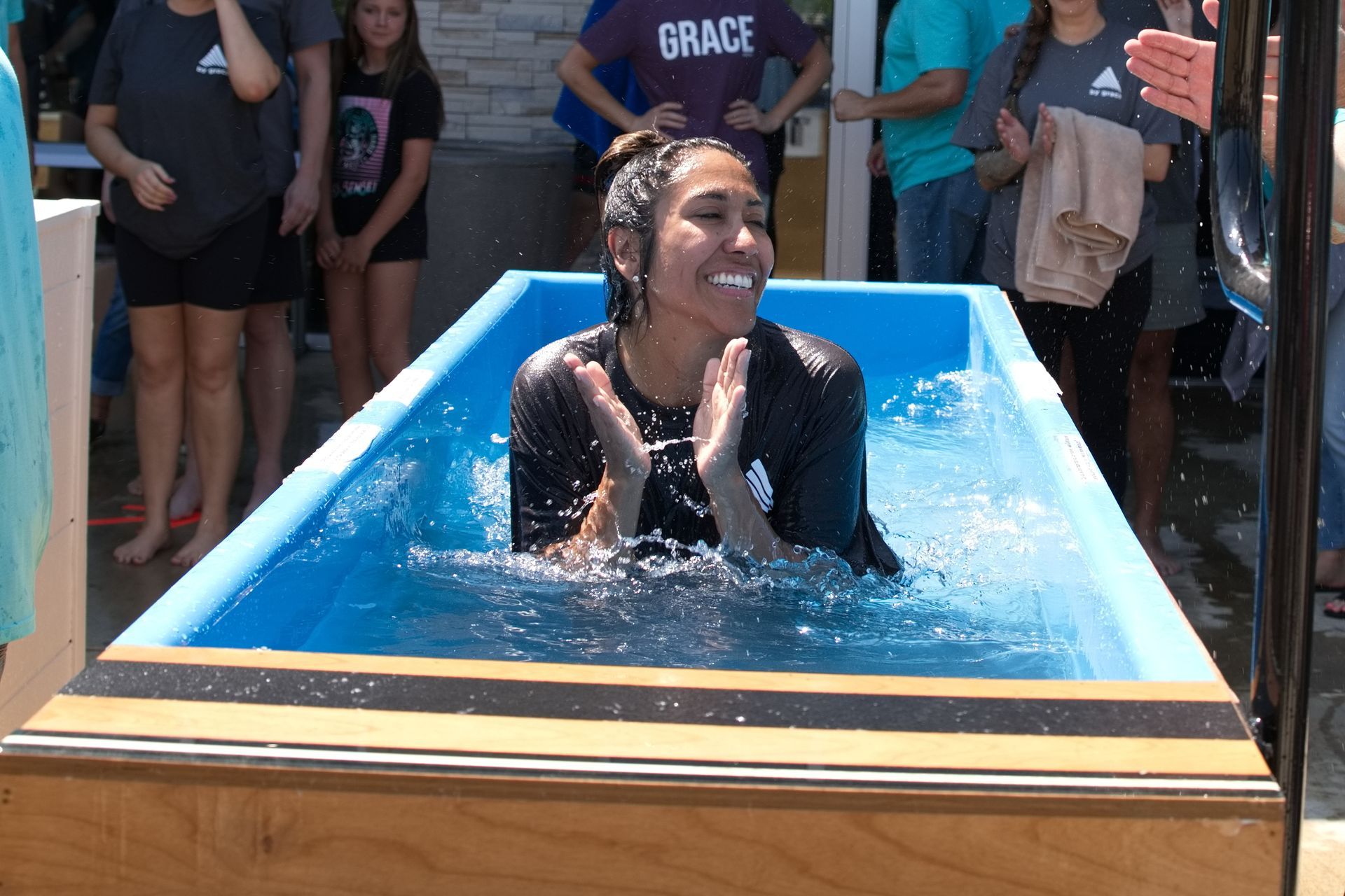 young woman in baptism tank, smiling