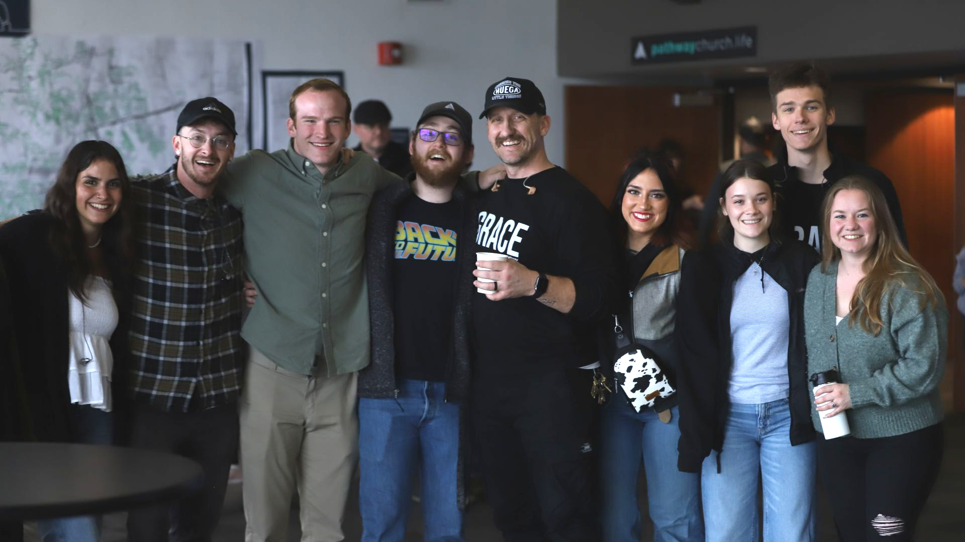 group of young adults standing inside