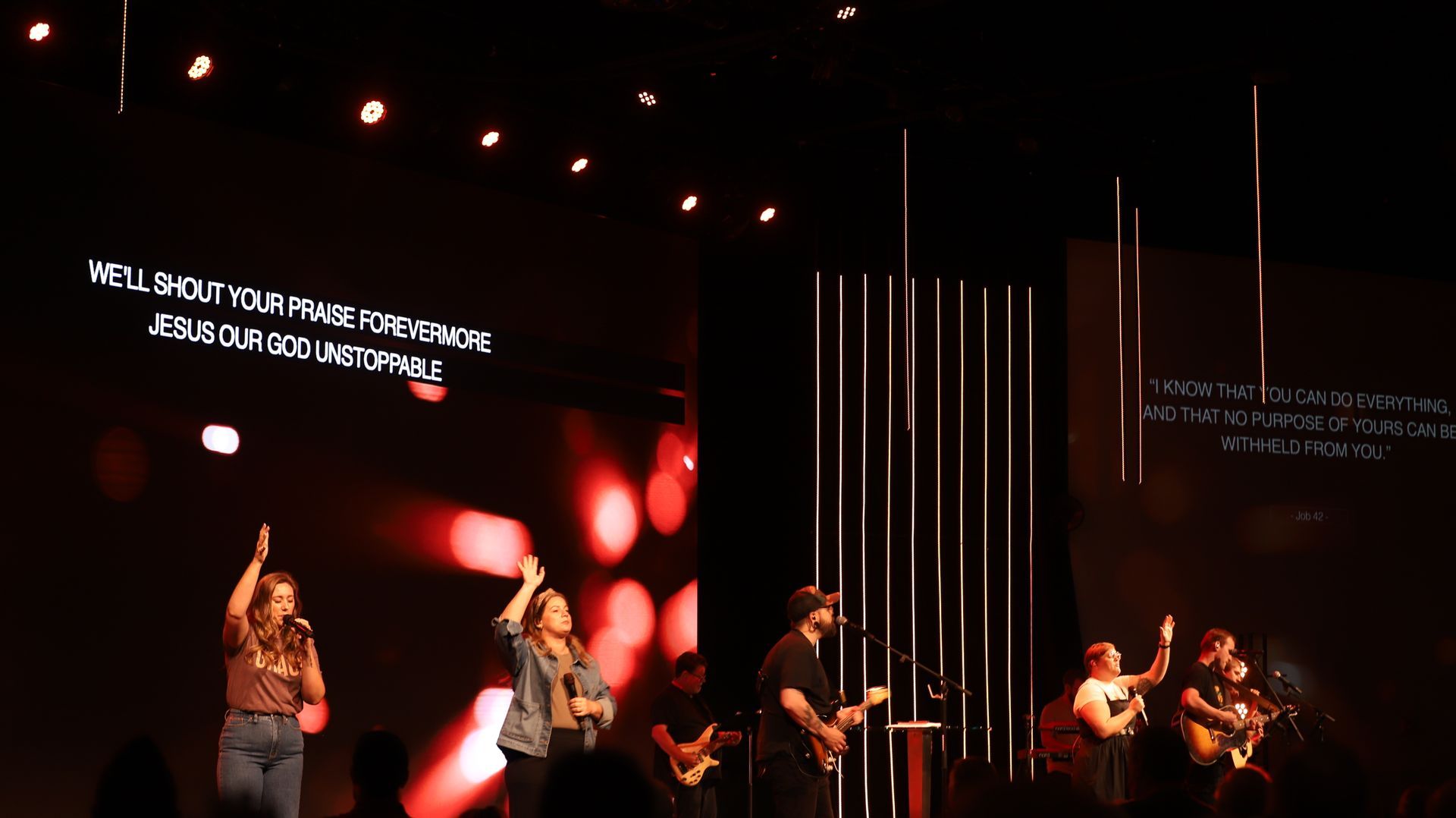 stage image of people singing and playing instruments