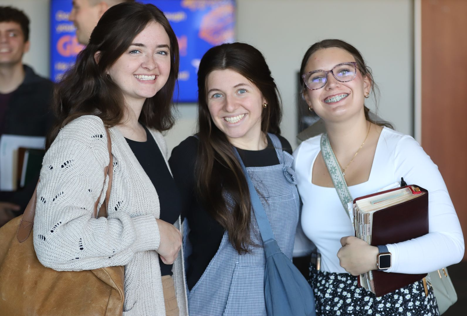 three smiling young adult females