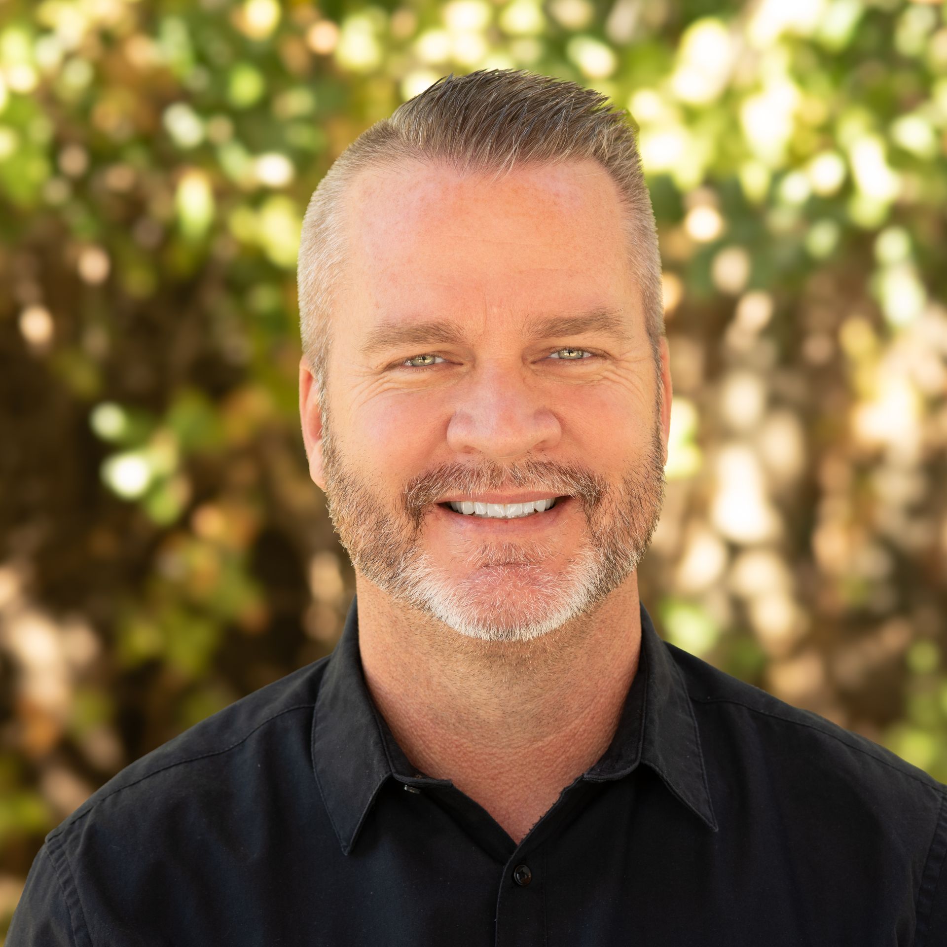 photo of smiling adult male pastor