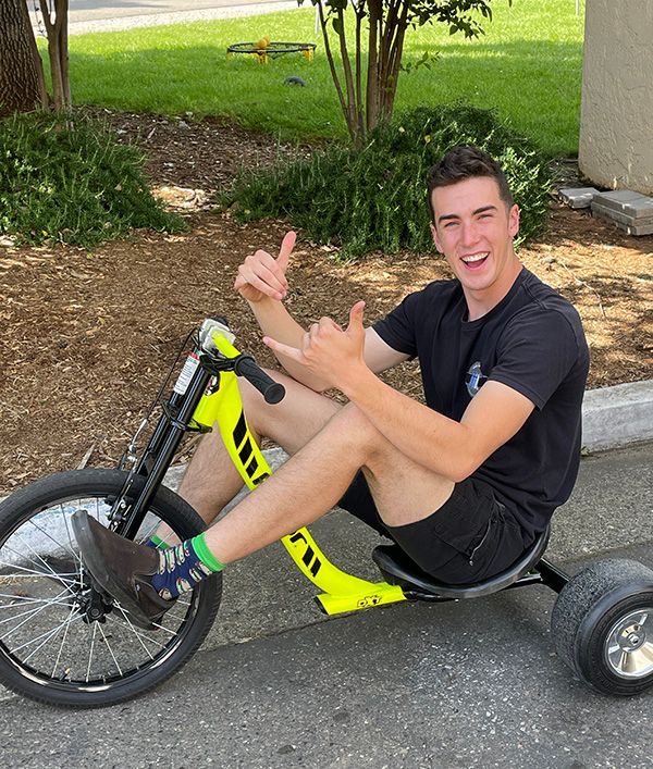 young adult man riding a large bike