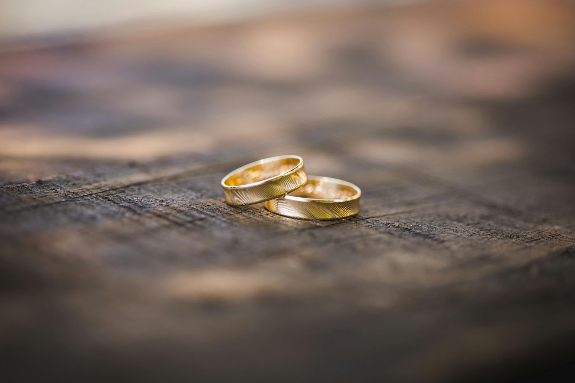two wedding rings on a wood
 board
