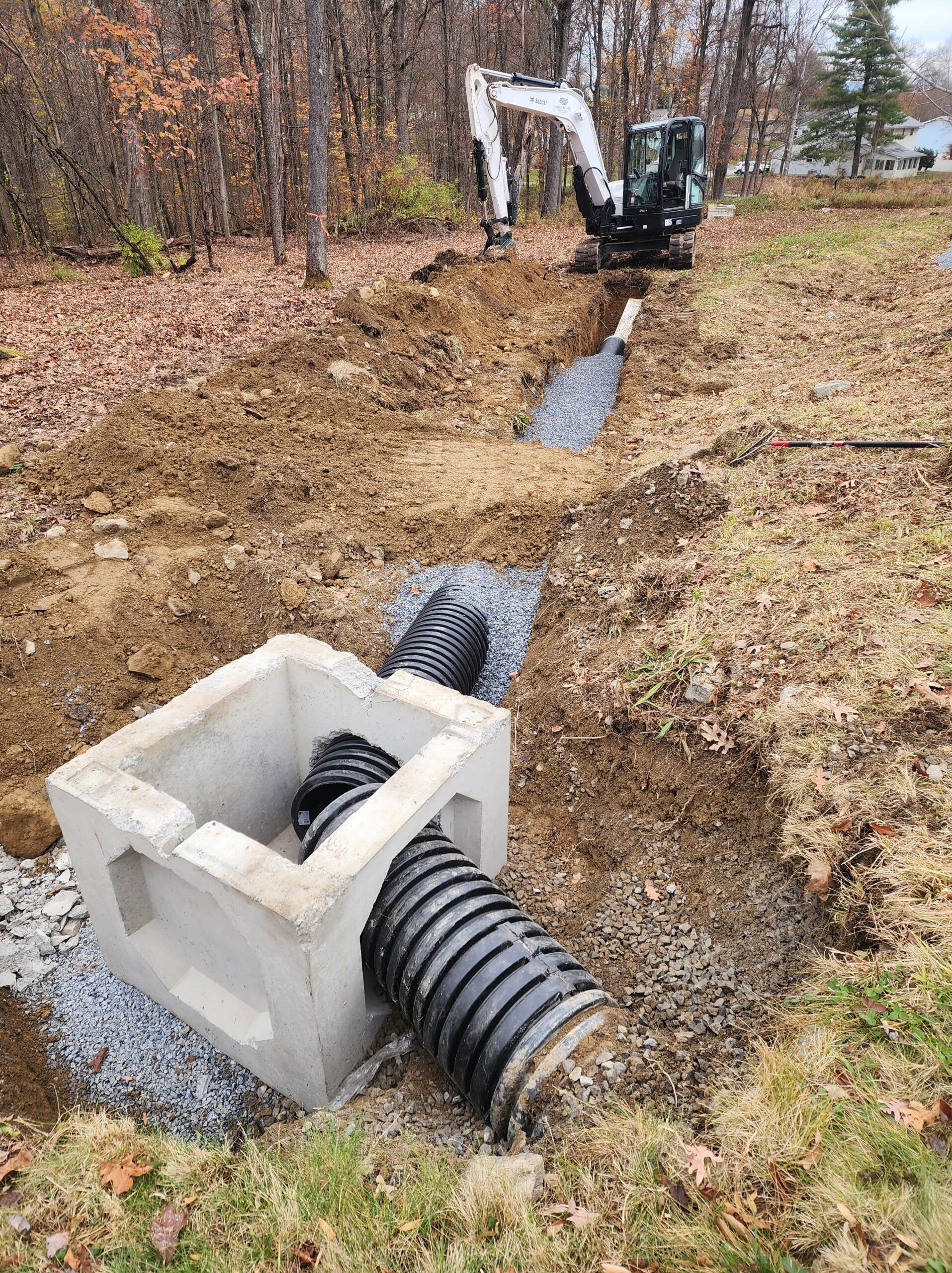 A drainage system is being installed in a yard.