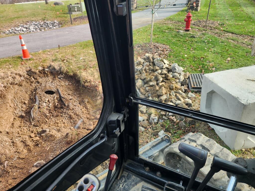 A person is driving a bulldozer on a dirt road.