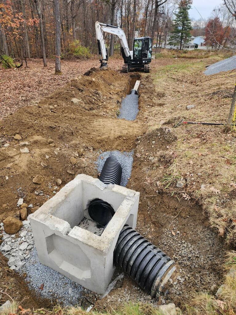 A drainage system is being installed in a yard.