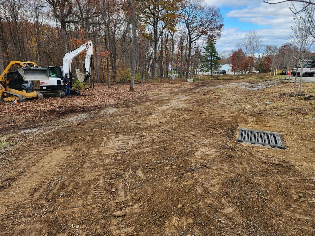 A bulldozer is sitting in the middle of a dirt field.