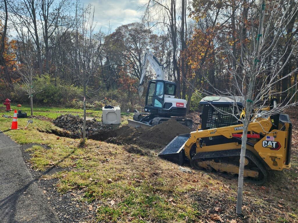 A bulldozer is digging a hole in the ground in a field.