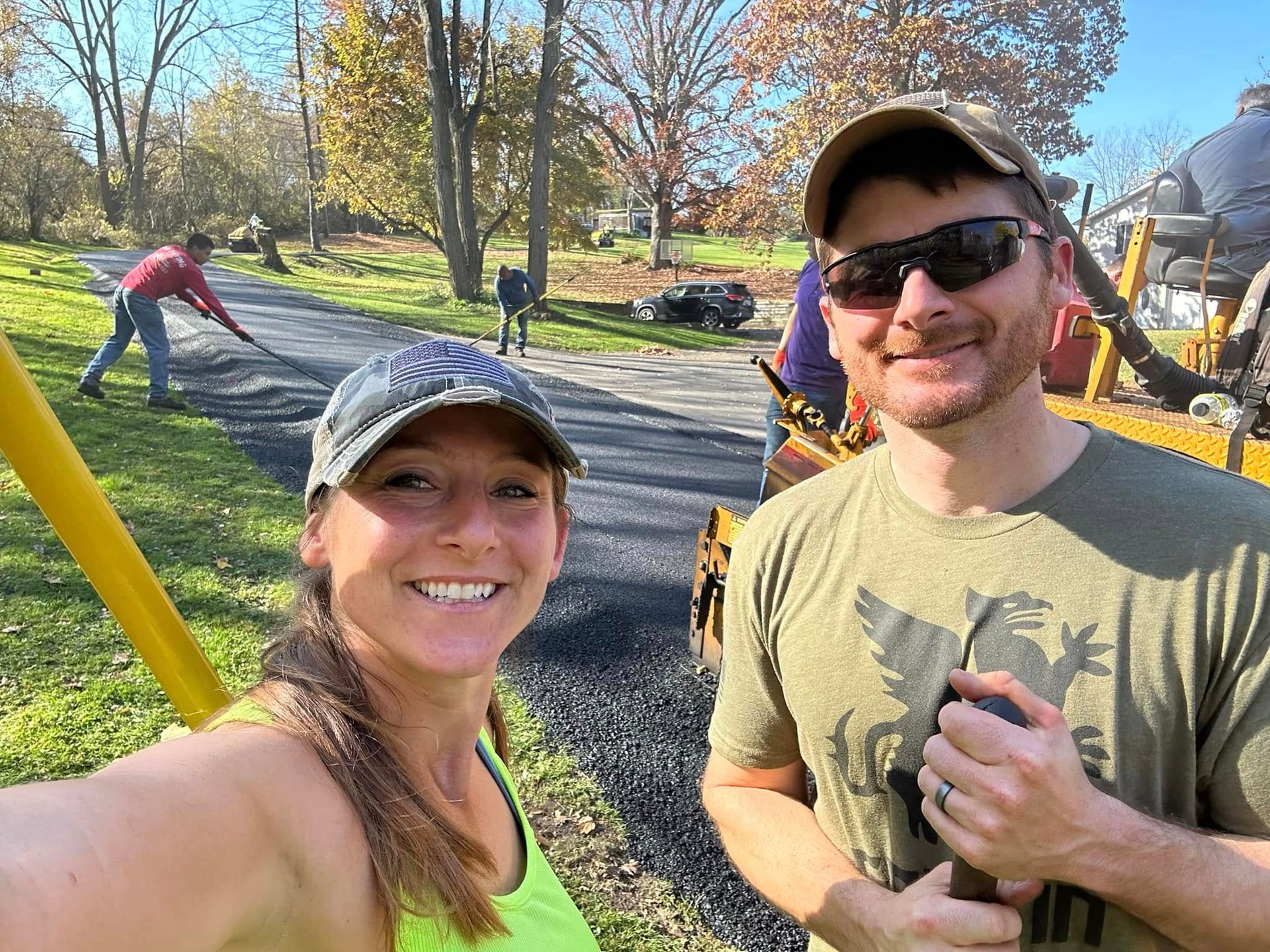 A man and a woman are standing next to each other on a road.
