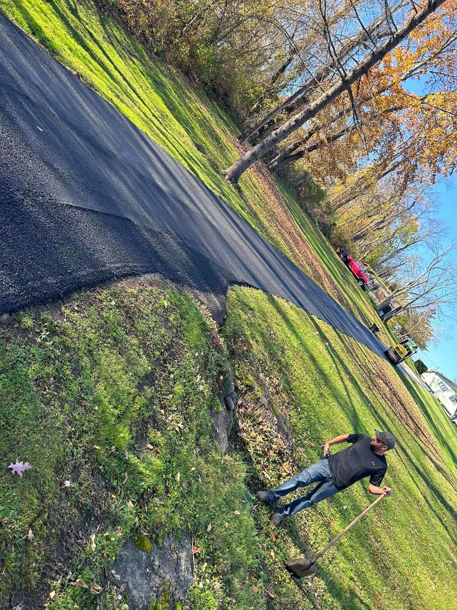A man is standing on the side of a road.