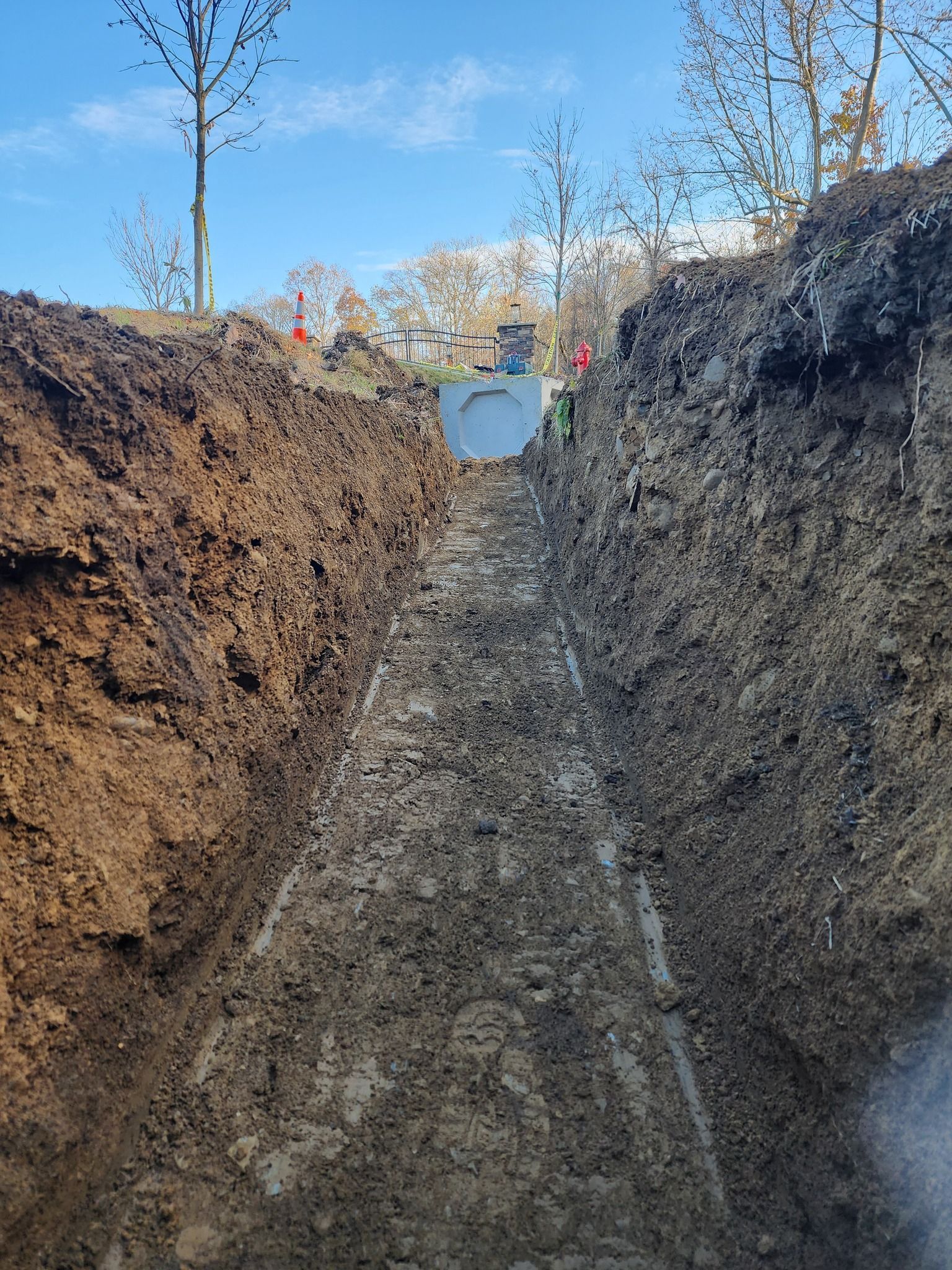 A large hole in the ground with trees in the background.