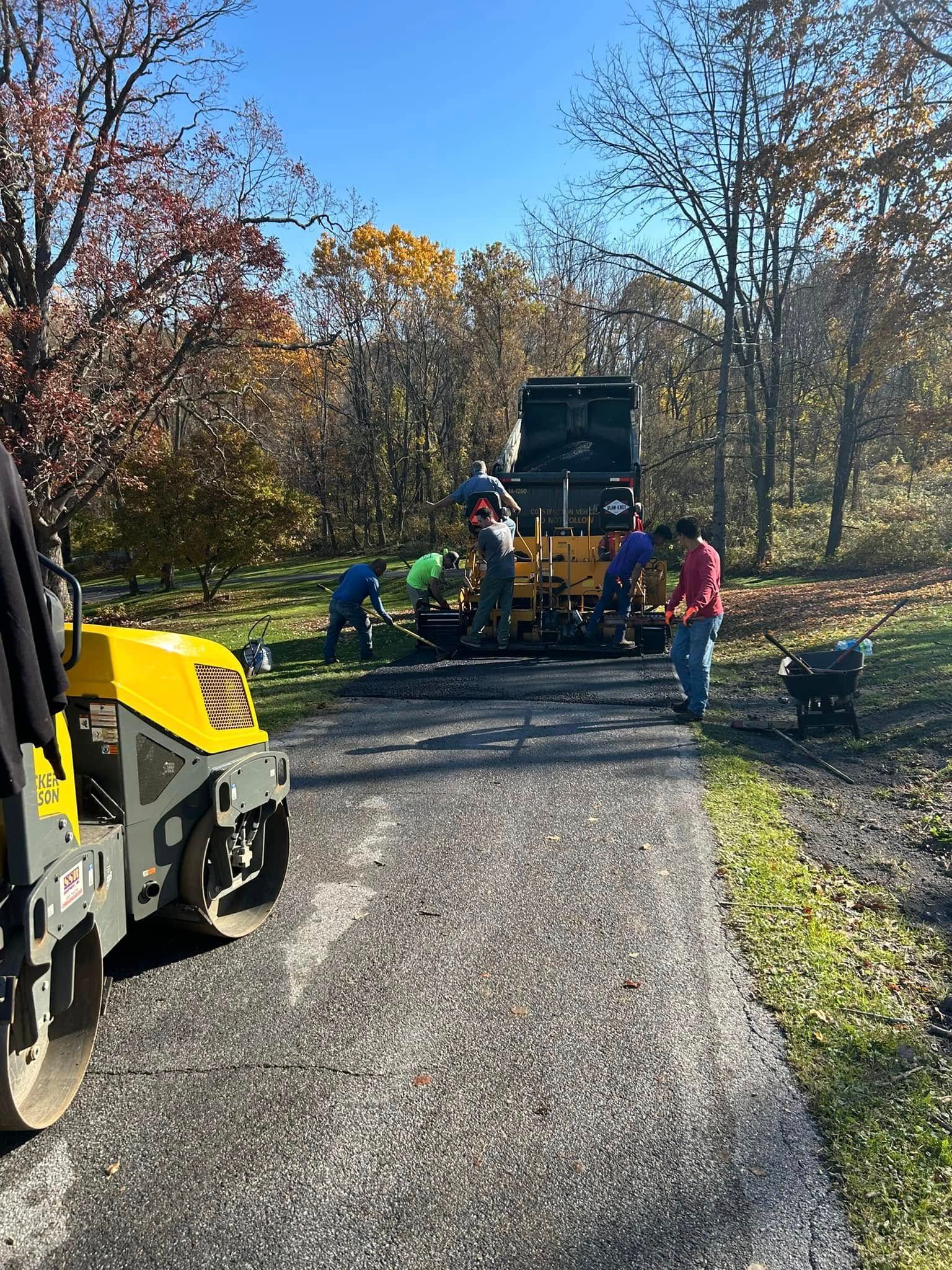 A group of people are working on a road.
