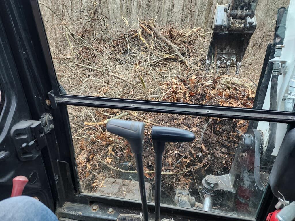 A person is sitting in the driver 's seat of a bulldozer.