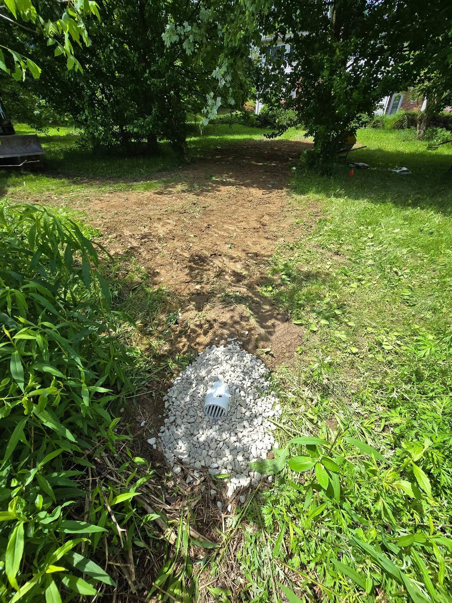 A white object is sitting in the middle of a grassy field.