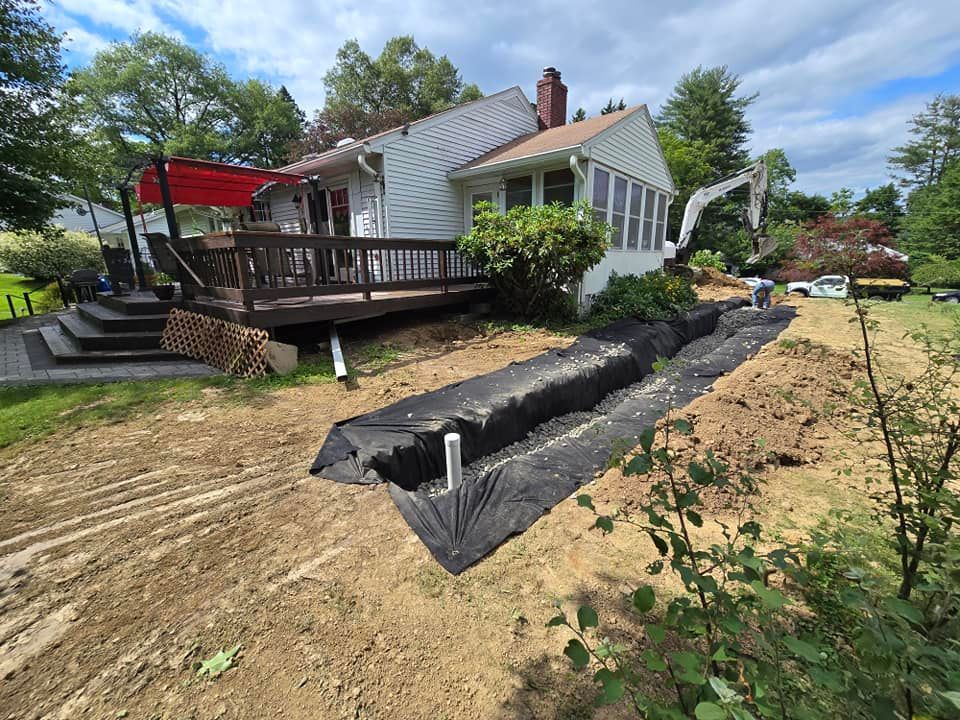 A house with a deck and a drain in front of it.