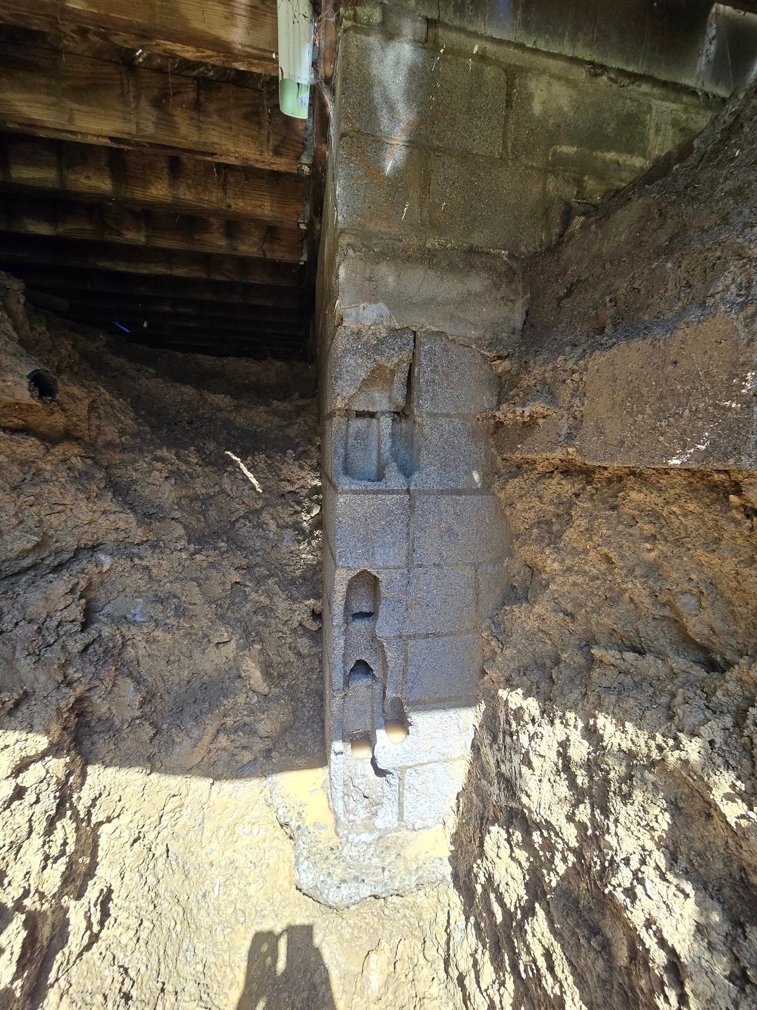 A large pile of dirt is sitting in the middle of a dirt field.