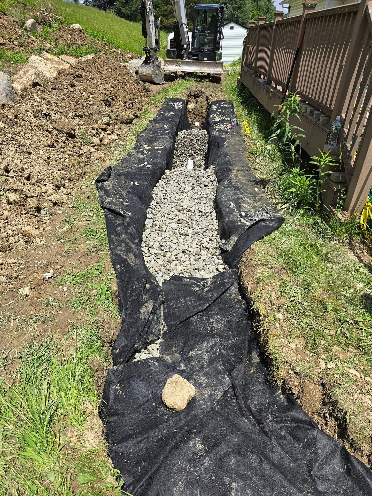 A drainage system is being built in a backyard.