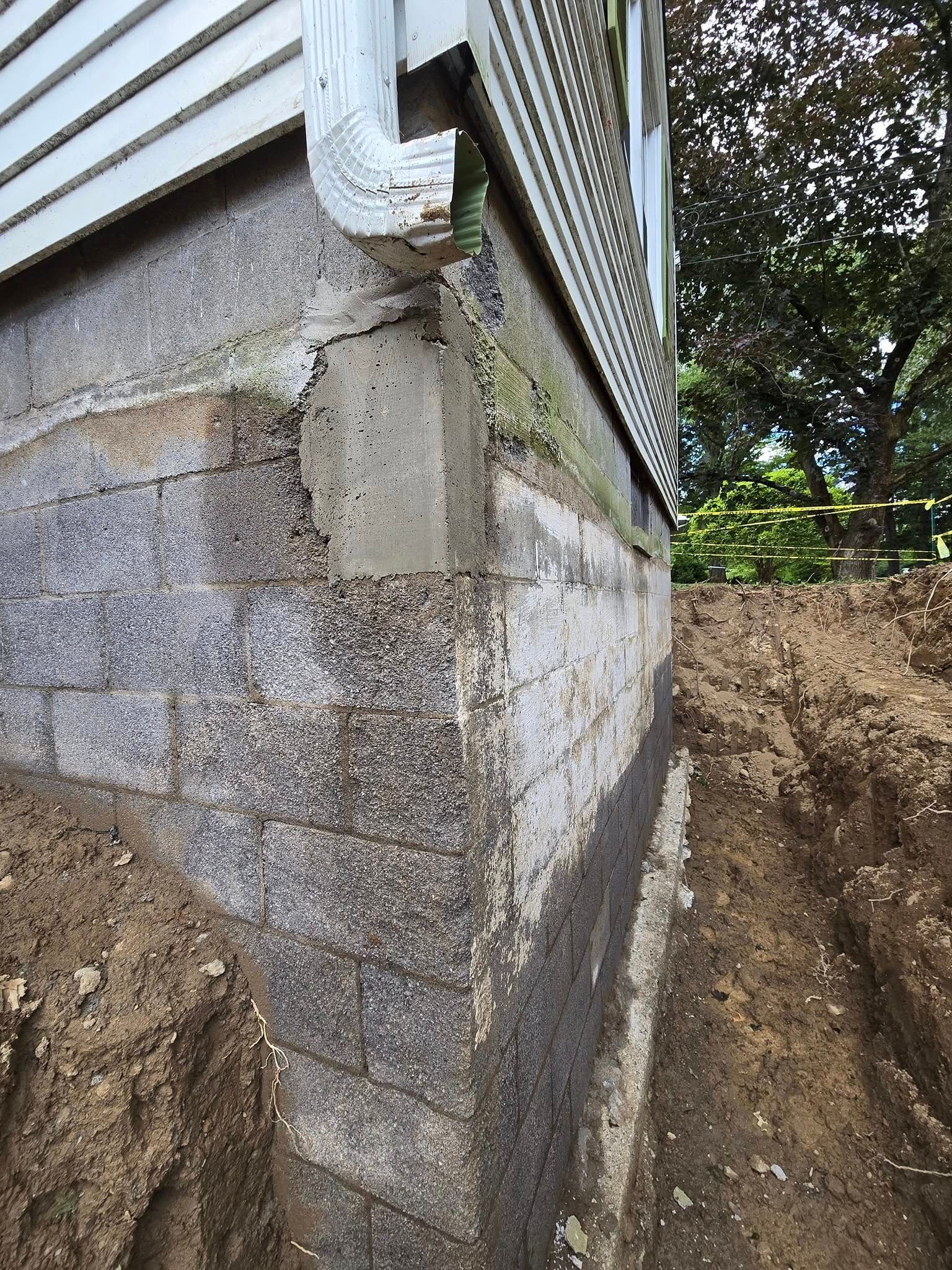 A house with a drain pipe on the side of it.
