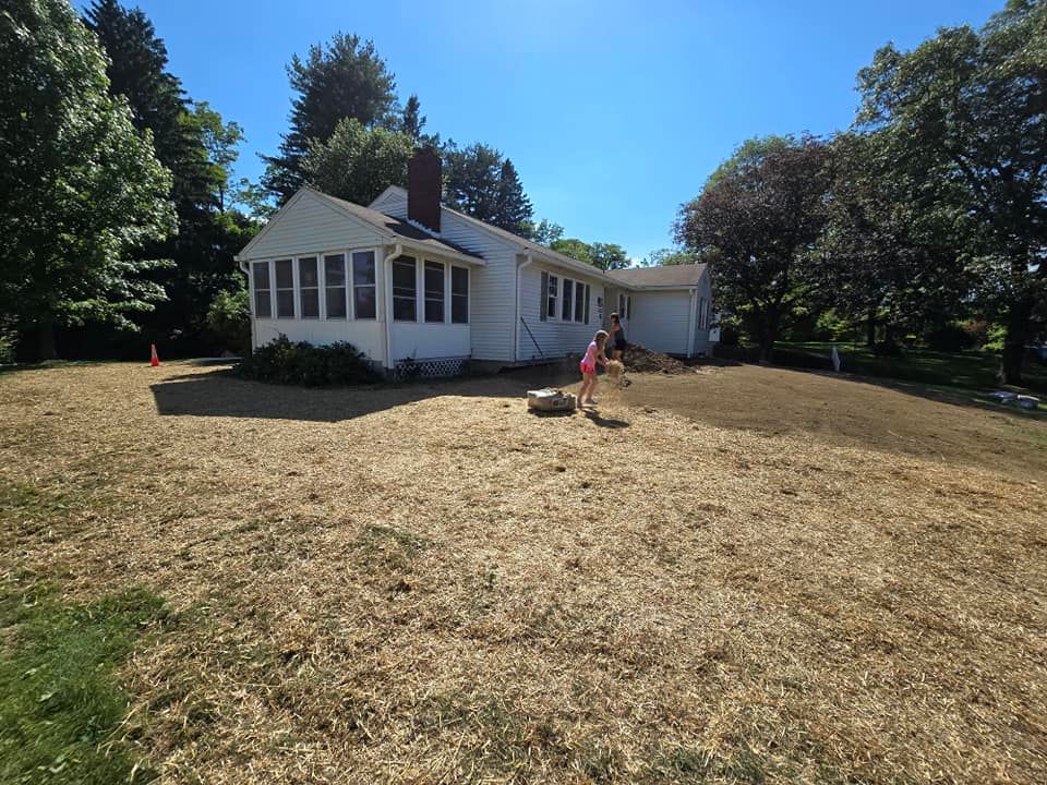 A white house with a lot of grass in front of it