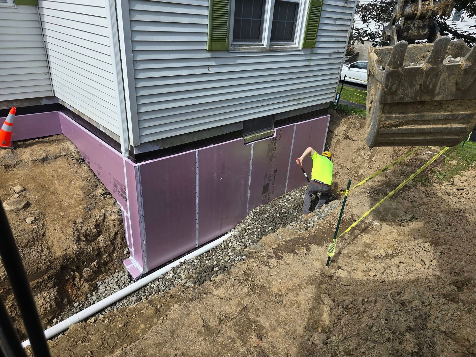 A man is working on the foundation of a house.