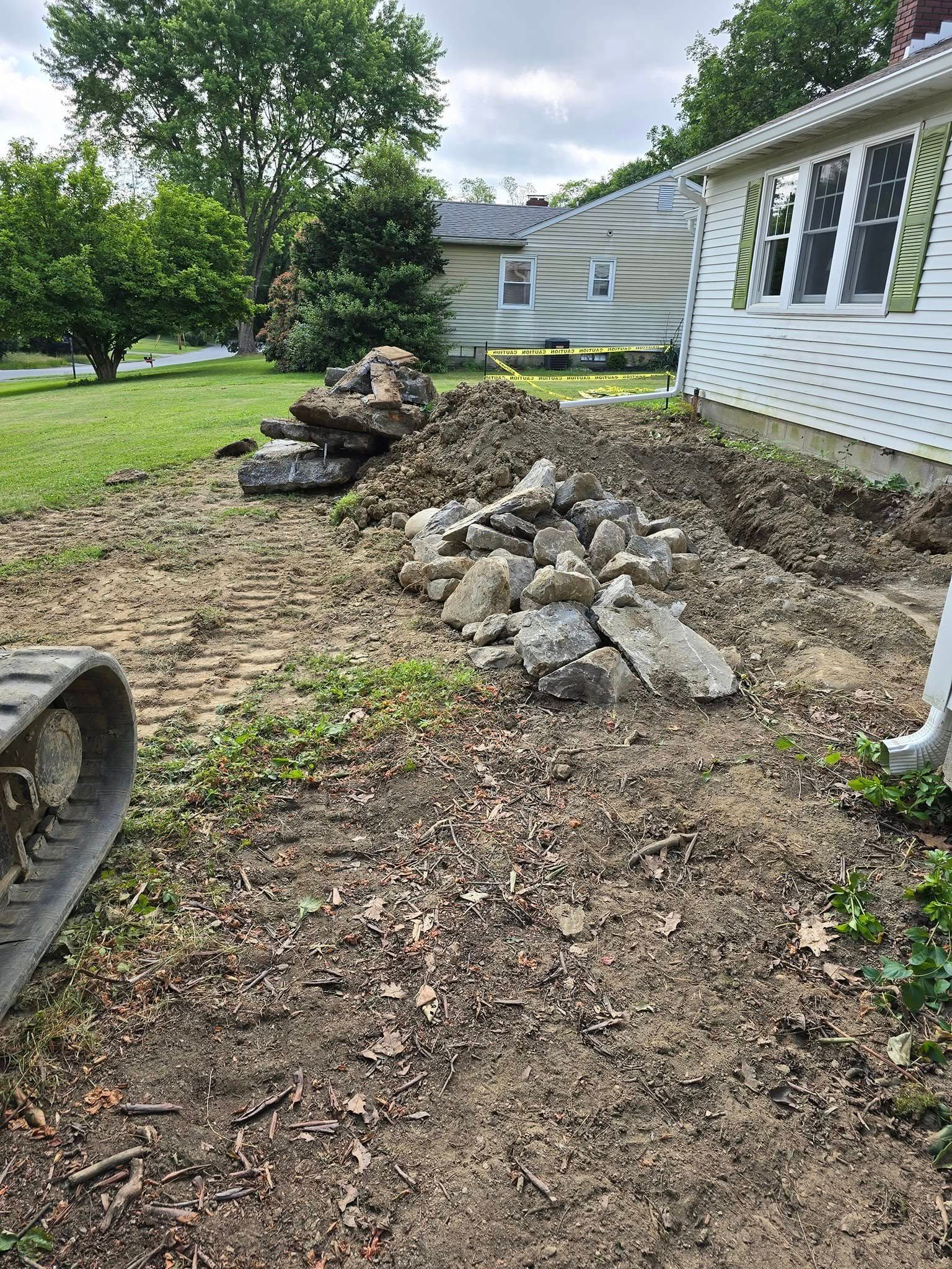 A pile of dirt is sitting in front of a house.
