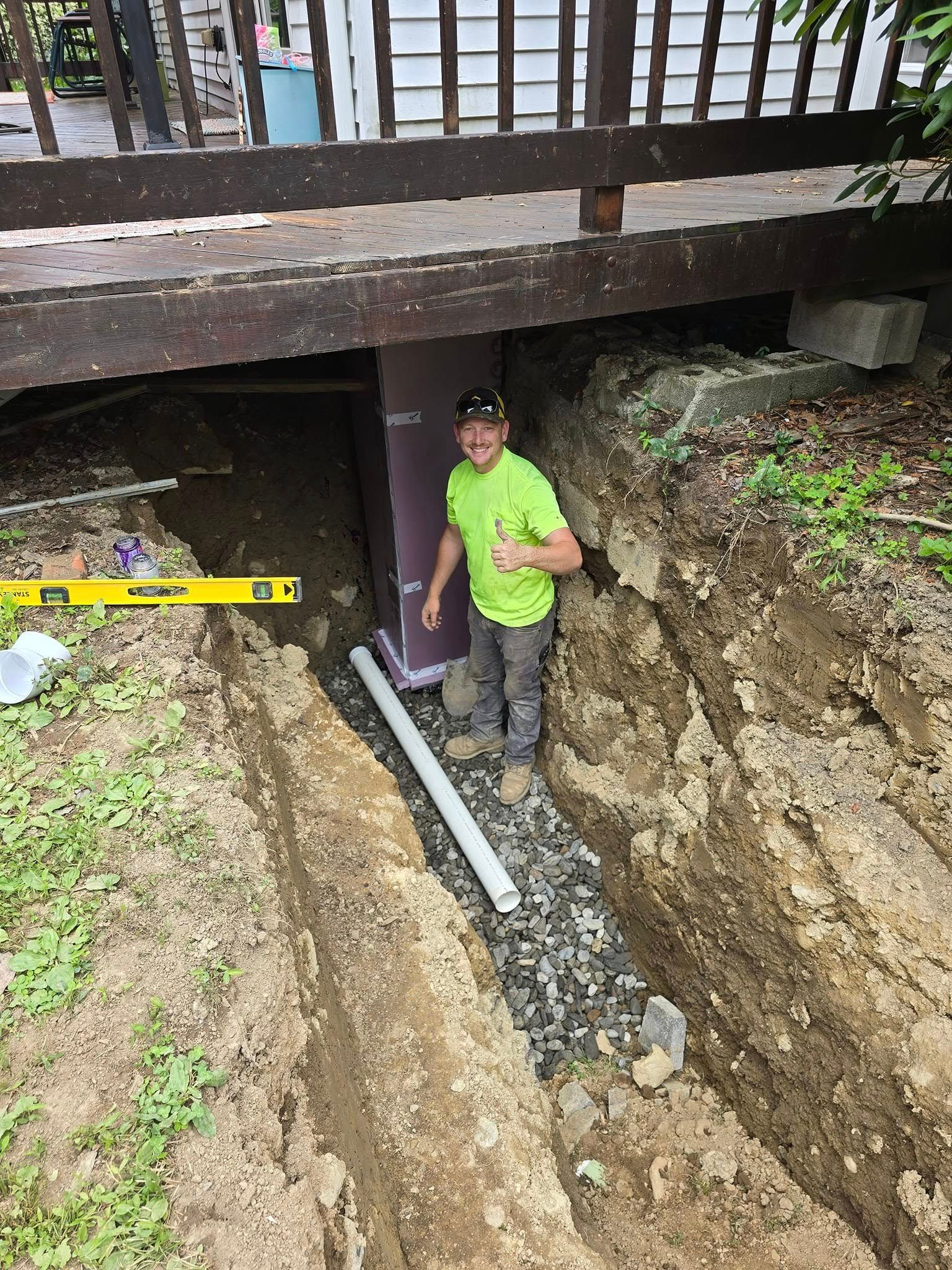 A young boy is standing in the dirt next to a pipe.