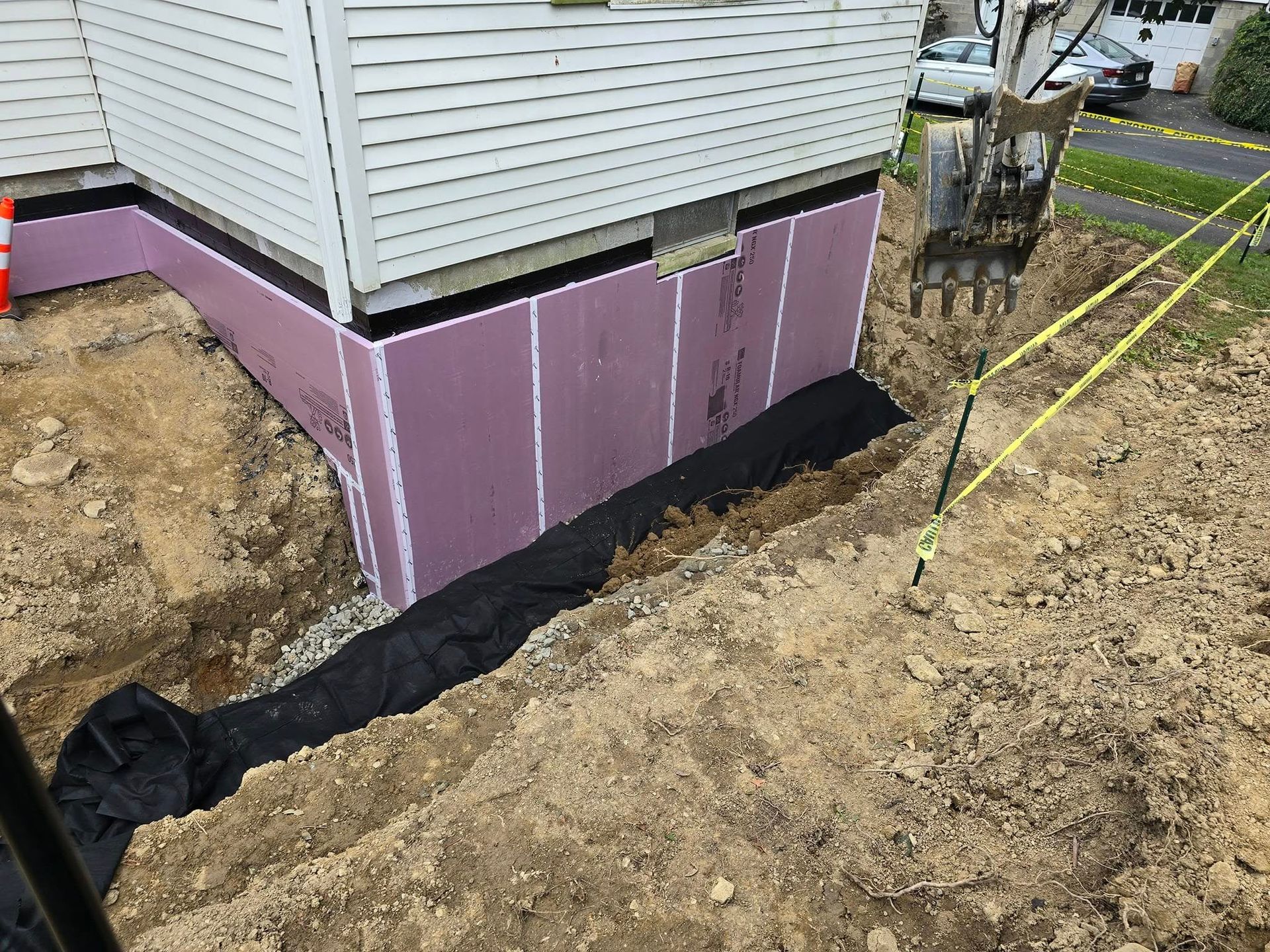 A house with a purple foundation is being built.