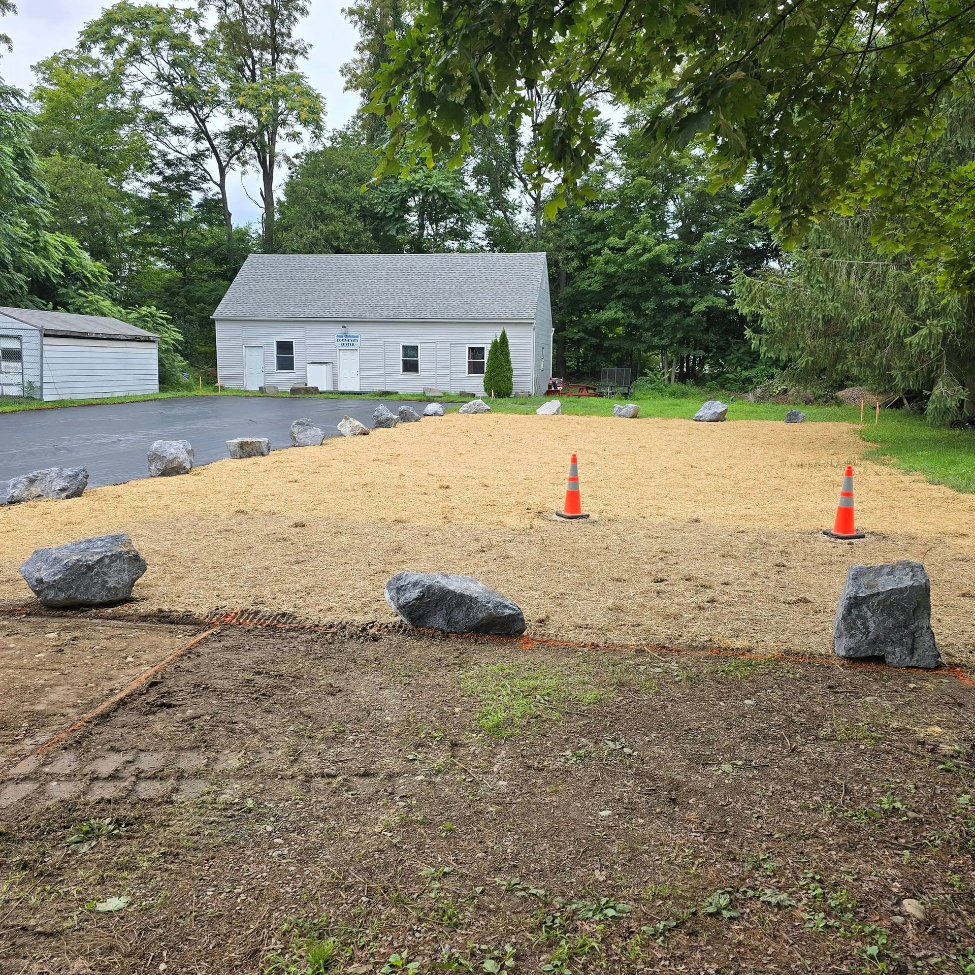 A large pile of dirt and rocks in front of a house.