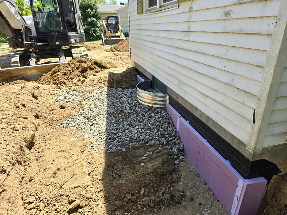 A house is being built with a bulldozer in the background.